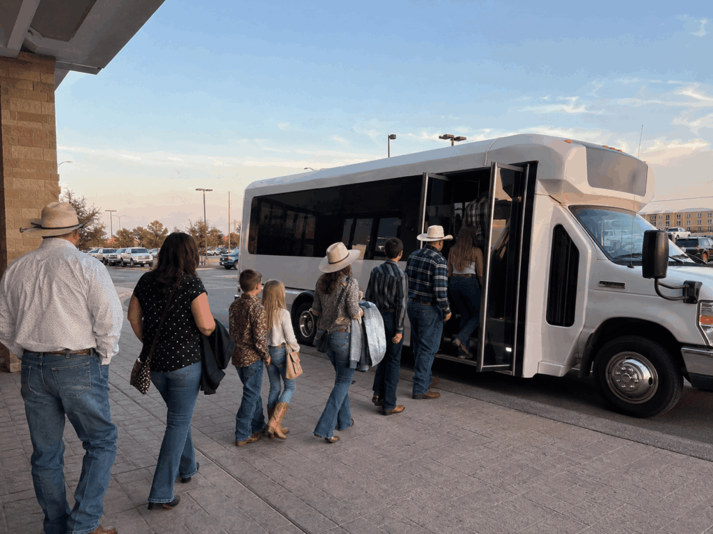 group boarding a charter bus at an abilene hotel before heading to the west texas fair and rodeo
