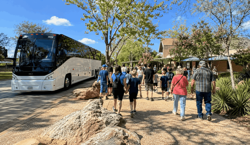 group arriving by charter bus at the abilene zoo entrance in nelson park