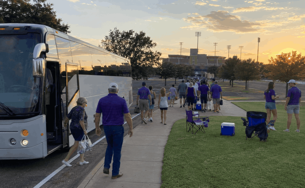 charter bus dropping off acu wildcat football fans near the east lot at wildcat stadium in abilene