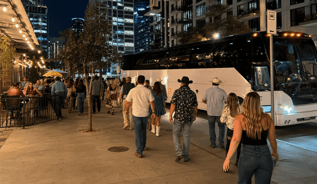 charter bus picking up concertgoers near downtown austin after an evening show