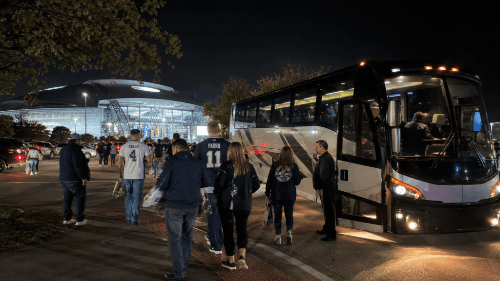 cowboys fans boarding a charter bus after a game near at&t stadium in arlington