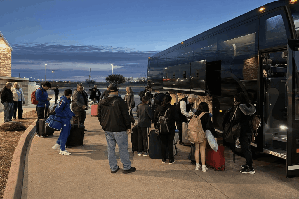 travelers boarding a charter bus at dfw airport after returning from a trip