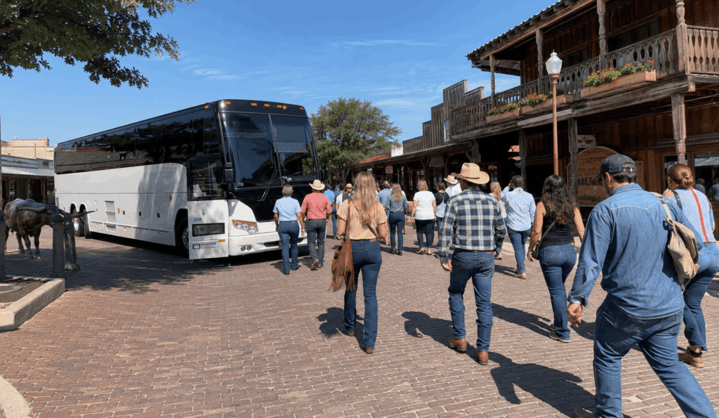 charter bus arriving with a group at the fort worth stockyards during a day trip from abilene