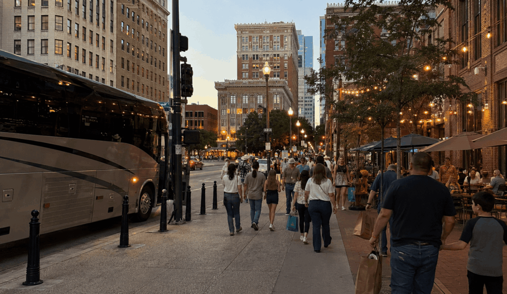 charter bus group exploring downtown fort worth near sundance square in the evening