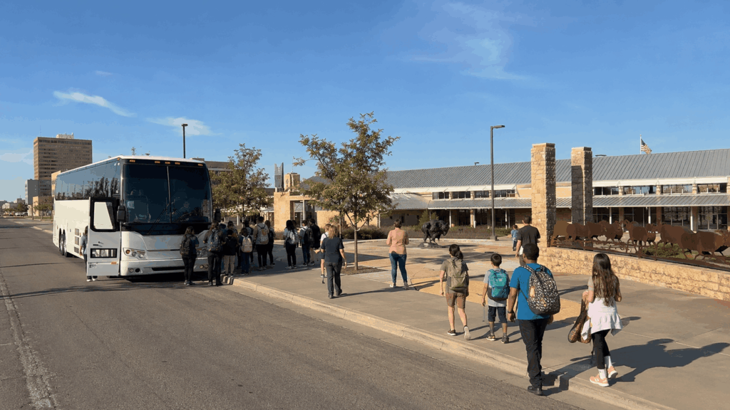 charter bus dropping off students and chaperones near the frontier texas entrance on north 1st street in downtown abilene