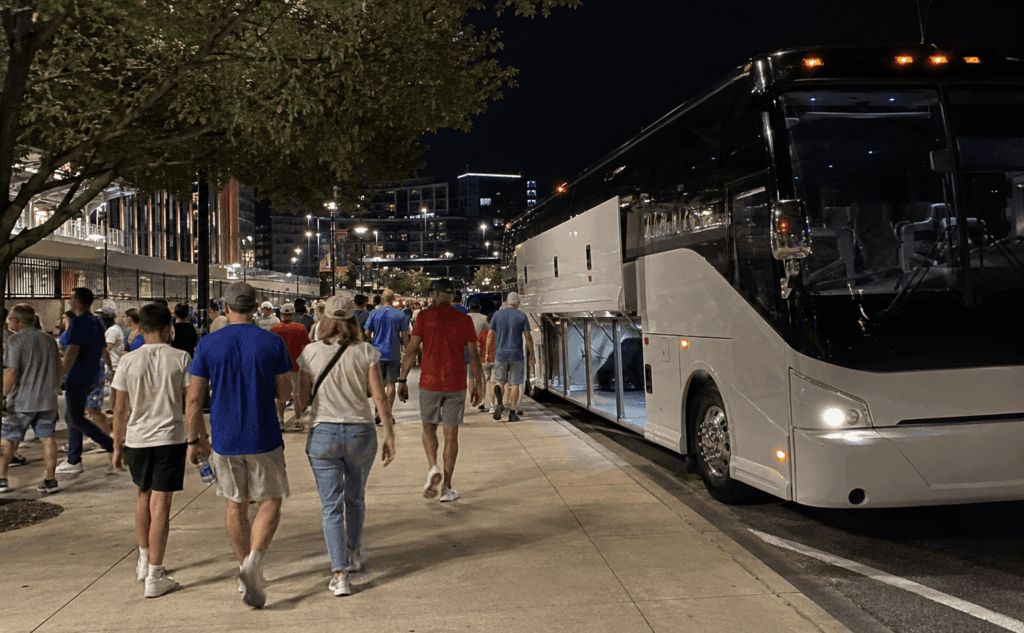 group returning to a charter bus after a texas rangers game near globe life field in arlington