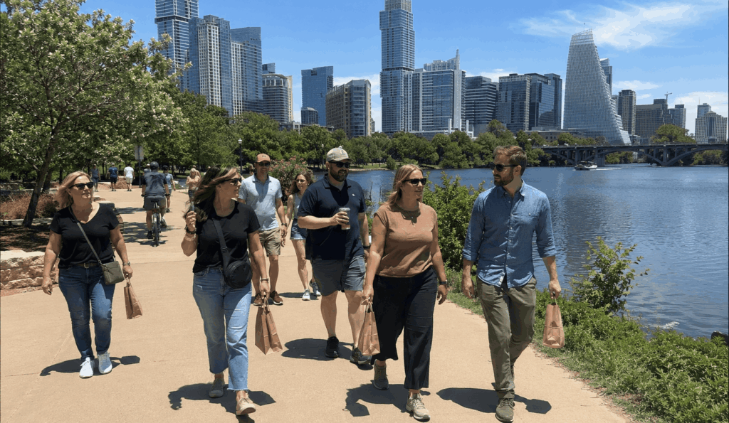 group from abilene walking along lady bird lake boardwalk during an austin charter bus trip